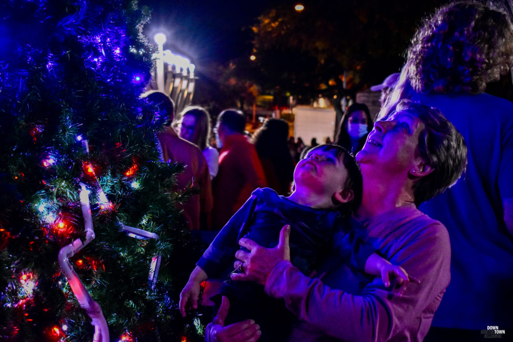 grandmother and child looking up at the lit downtown austin alliance holiday tree