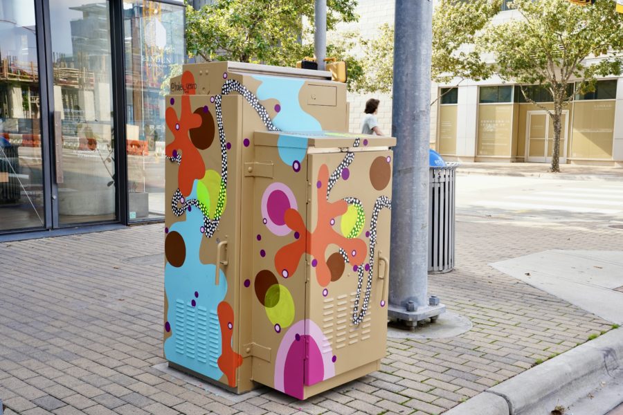 Electrical box mural painted bright abstract colors in downtown for the downtown austin alliance foundation's artbox program. Mural by hailey gearo