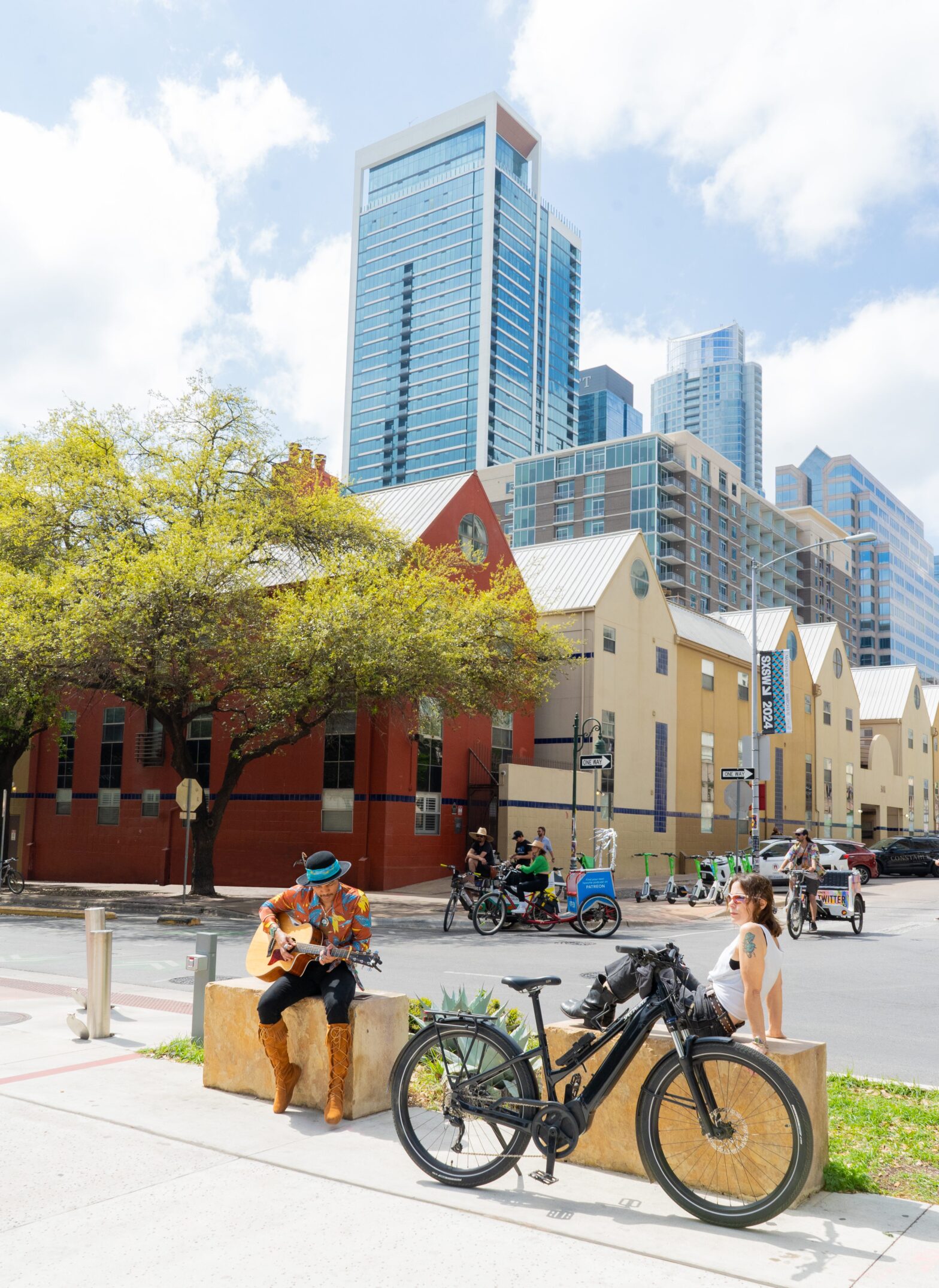 downtown convention center musician biker streetscape skyline old new